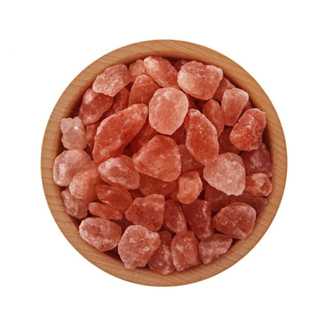 Coarse dark pink Himalayan salt granules in a wooden bowl